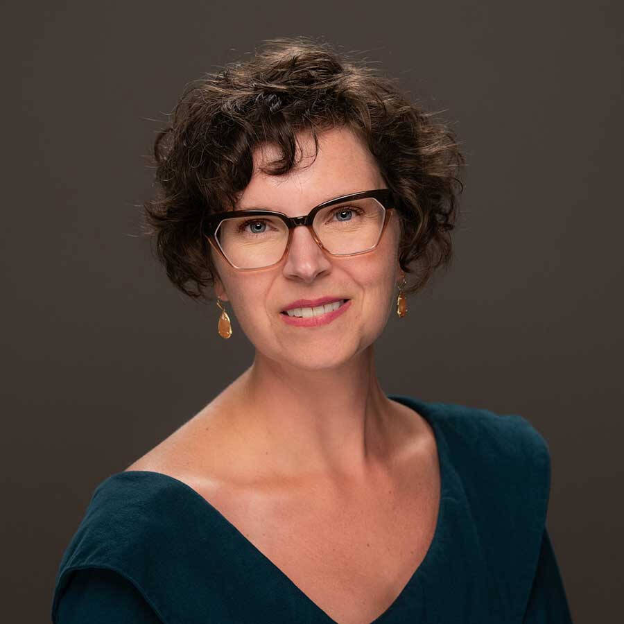 Annie Bélanger in studio lighting with a dark teal top